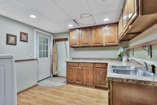 Laundry room walks up to garage, ample storage cabinets and even a kitchen sink!