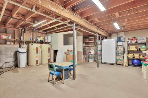 Lowest level storage and mechanical room, double water heaters for ample heating. Home also has a Generac Whole House back up generator that is fueled by the second propane tank.