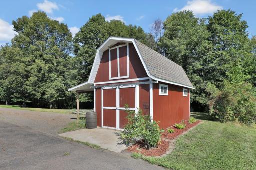 Separate garden shed with loft for storage of lawn more, gas cans and garden tools.