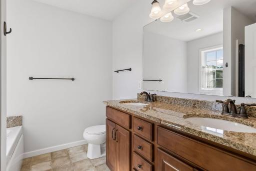 Primary bath with double vanity sink with separate shower and jetted tub