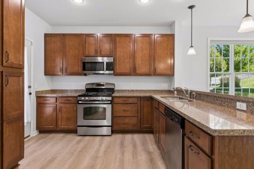 Kitchen with pull out drawers, newer lighting, recessed garbage bin