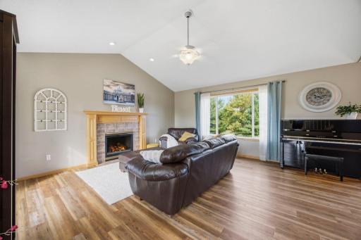 Step into the home and you will be instantly greeted with vaulted ceilings and large windows for an open and bright feel to the space! The cozy gas fireplace and wood mantle that anchors the room beautifully. Fireplace is virtually enhanced.