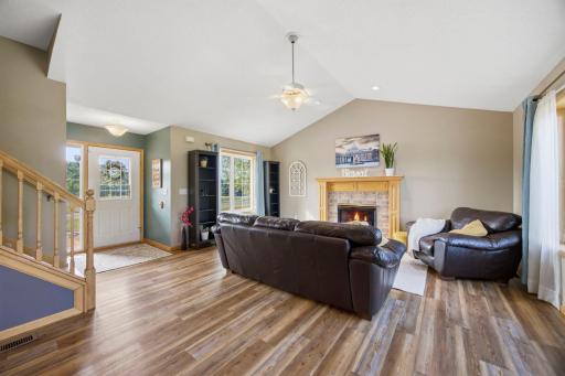 Note the luxury vinyl plank flooring on this level to enhance the space. To the left is the foyer area, which is light and bright as you greet guests. Fireplace virtually enhanced.