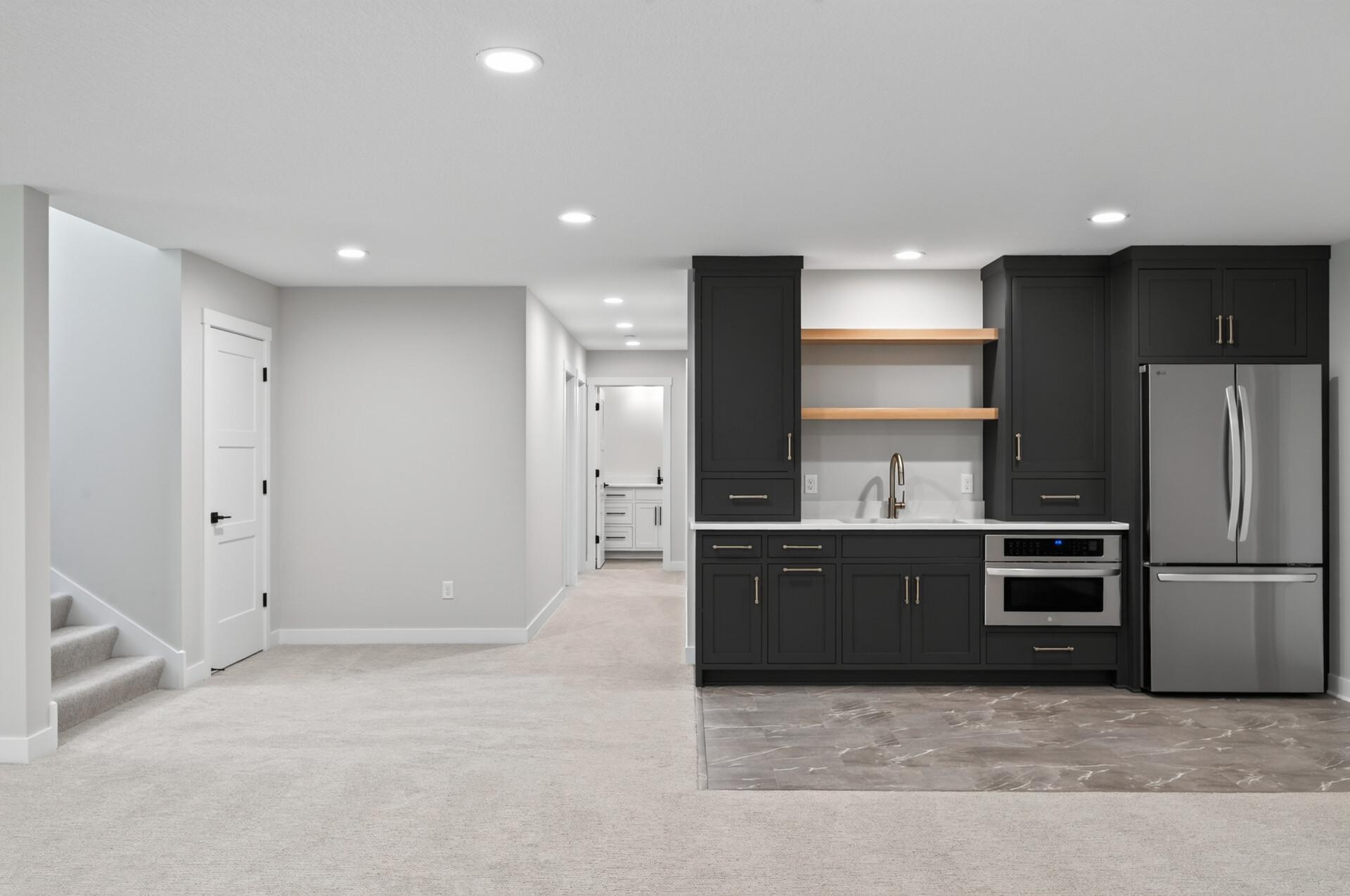 Lower level wet bar area with a full-size fridge and microwave!