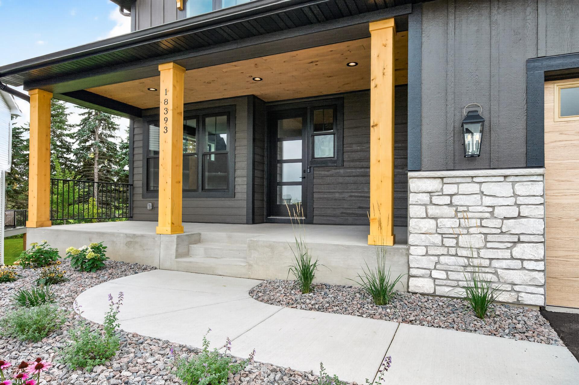 The front door offers cedar ceiling and columns - such a beautiful accent color!