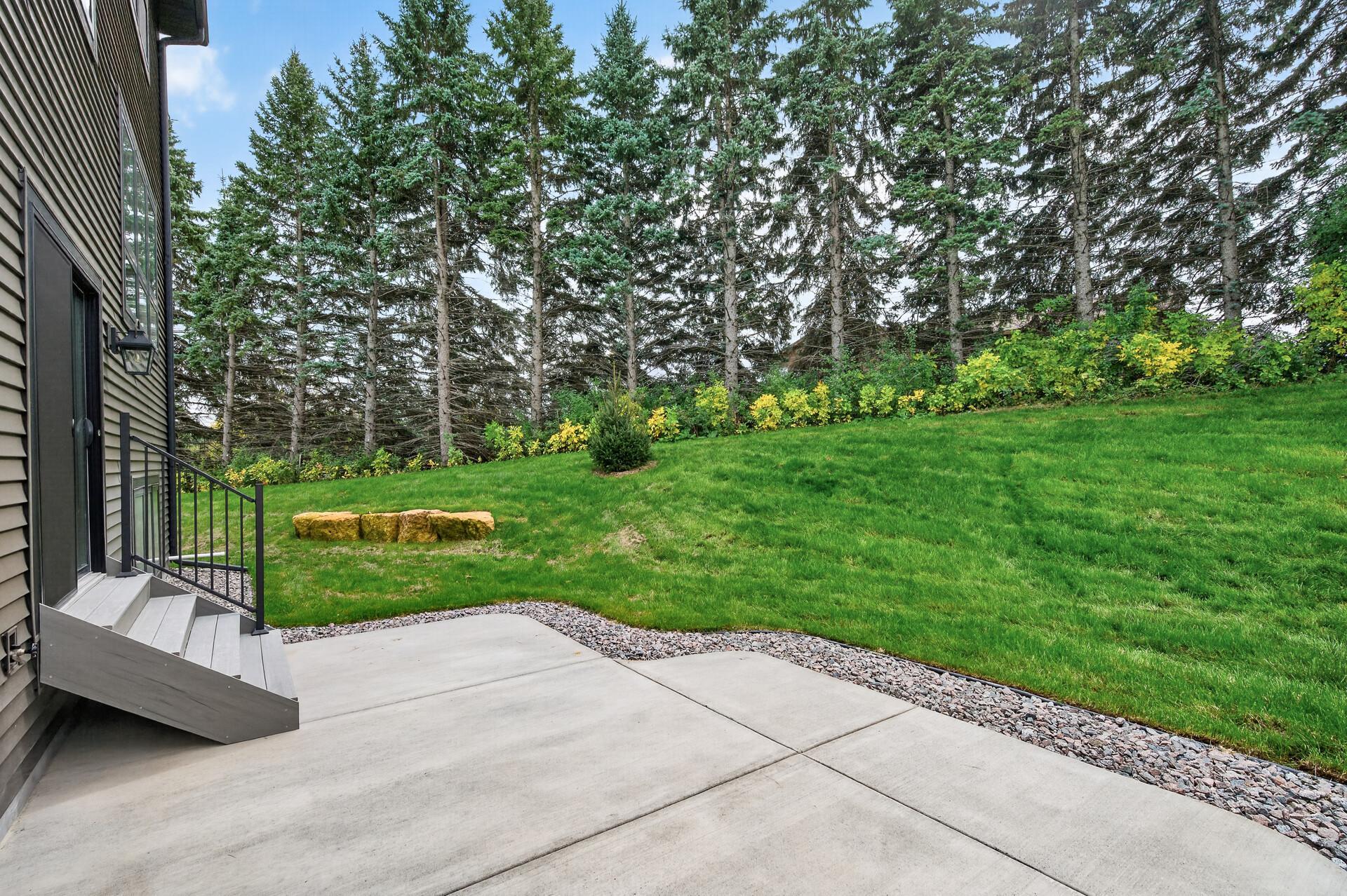 The view of the backyard with lush evergreens creating natural privacy!