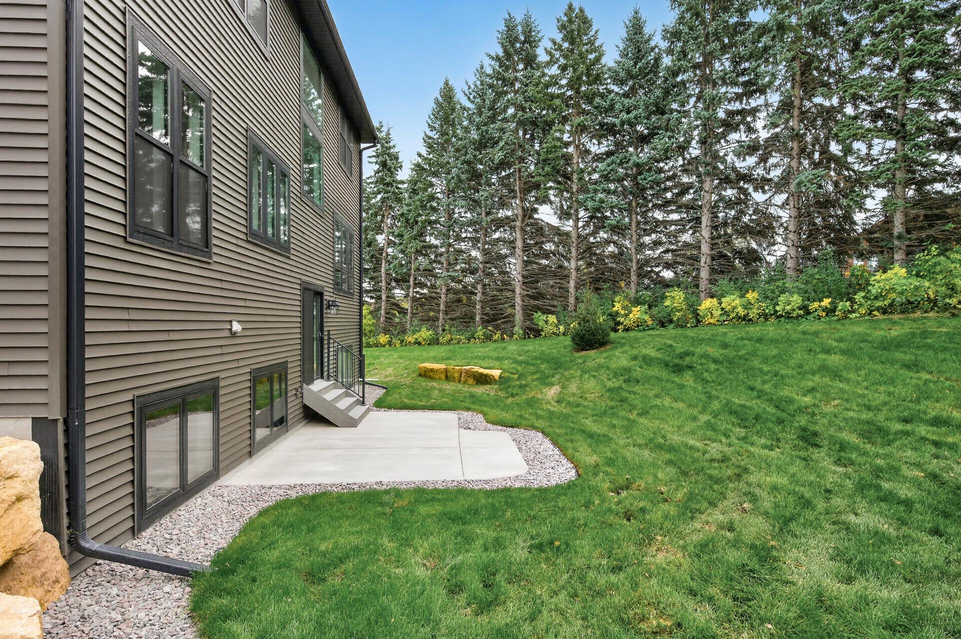 The view of the backyard with lush evergreens creating natural privacy!