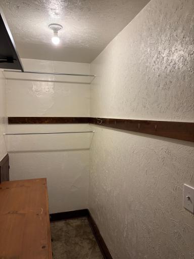 Walk in closet in the main floor primary bedroom