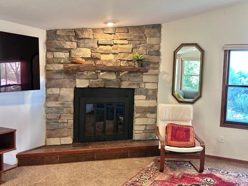 Step down to the vaulted ceiling family room with cozy wood burning fireplace. This is a good size room that even has a storage closet.