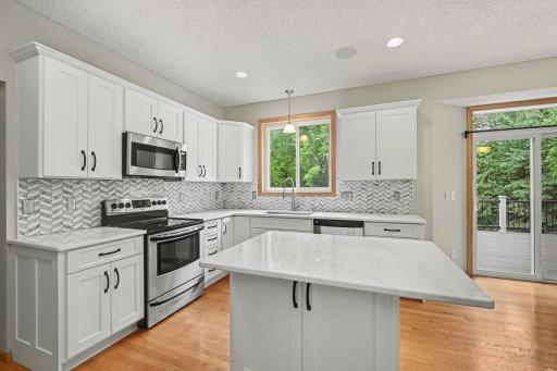 Updated kitchen with new cabinets, counter tops, and custom backsplash