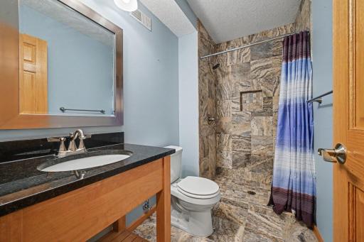 Lower level bathroom with custom tile and heated floors