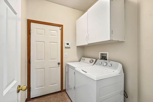 Convenient main level laundry with extra storage.
