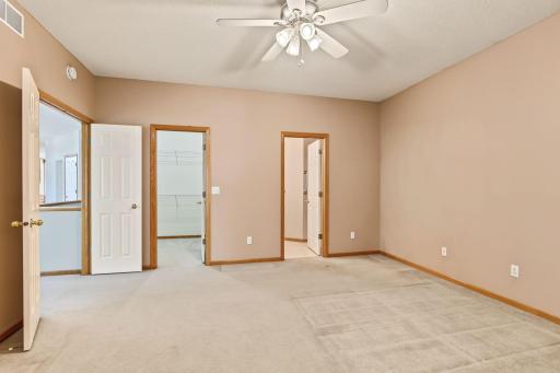 Primary bedroom showing entrances to walk-in closet and private 3/4 bath.