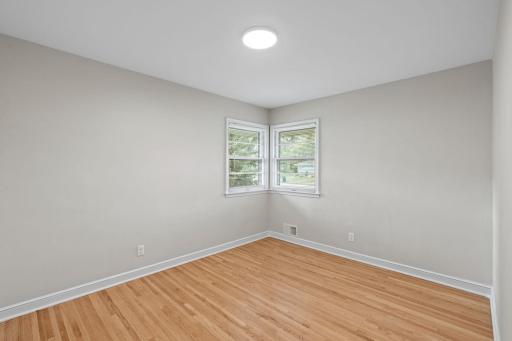 One of the main floor bedrooms. All have nice natural light, and hardwood floors.