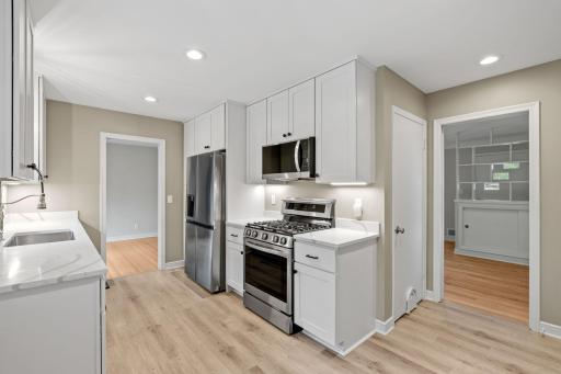 Kitchen has been updated with large cabinets, stainless appliances and quartz counter tops.