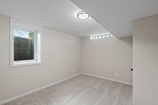 Lower level bedroom has egress and glass block windows.