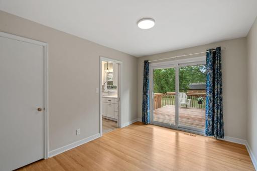 Flex room off kitchen separates the space with a hidden pocket door and opens to back deck via sliding glass door. Another versatile space can be used for a formal dining room, office or even a bedroom.