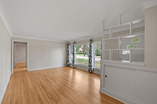 These hardwood floors are stunning! Pretty mid century details add nice design to clean function with storage and shelves.
