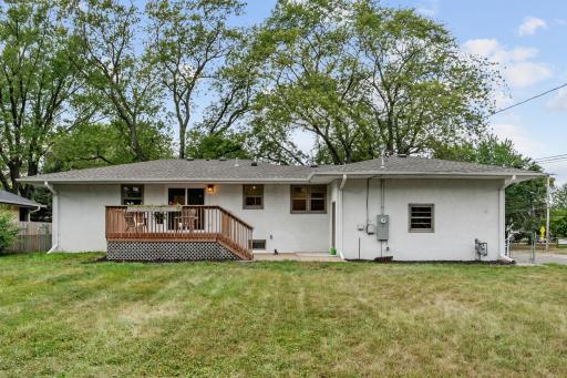 Well maintained exterior of stucco and brick, large cedar deck and concrete patio in fully fenced backyard.