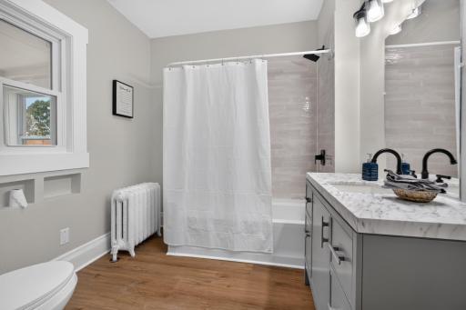 New full bathroom on the main level with new a tub, vanity and toilet.