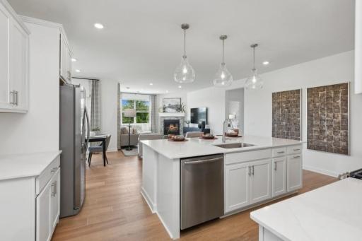 The open-concept design connects the kitchen and Great Room beautifully, with a large center island and clear sightlines that make entertaining easy.