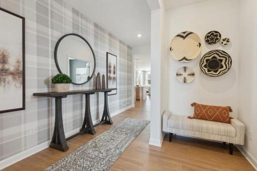 Bright and welcoming entryway with warm flooring and a convenient layout offering easy access to the main-level living spaces.