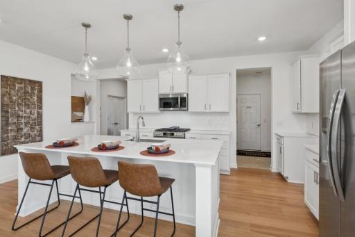Designed for both function and style, this spacious kitchen features an oversized island, abundant cabinetry, stainless steel appliances, and an open layout that keeps everything connected.