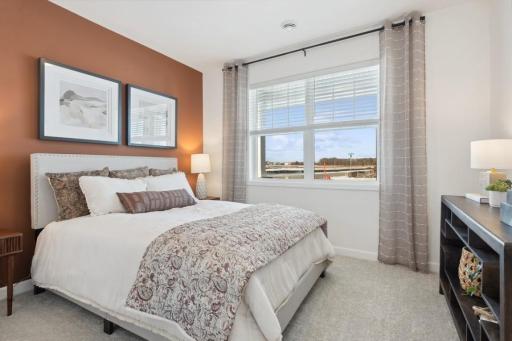 Bright and inviting second bedroom offers generous space, abundant natural light, and a large closet for plenty of storage.