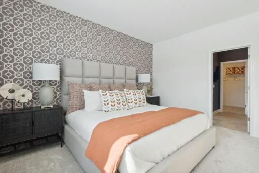 Spacious owner’s suite is filled with natural light and offers a peaceful private retreat with plenty of room for a full bedroom furniture arrangement.