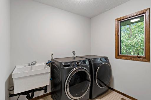 Main floor laundry room with a sink off the kitchen