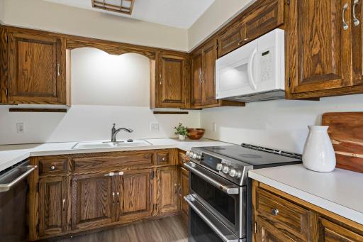 Step into the kitchen with updated stove, range, and dishwasher. Plenty of counter and cabinet space