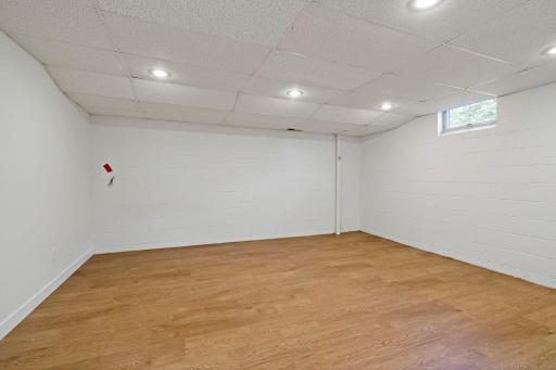 First versatile lower-level flex room ideal for a home office, exercise room, craft room, or hobby space.
