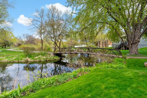 The home sits on a private pond with trails and easy access to Green Oaks Park
