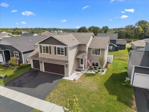 Inviting exterior featuring a three-car garage and covered front entry.