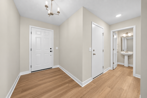 Bright entry with hard-surface flooring and convenient access to garage and a nearby half bath.
