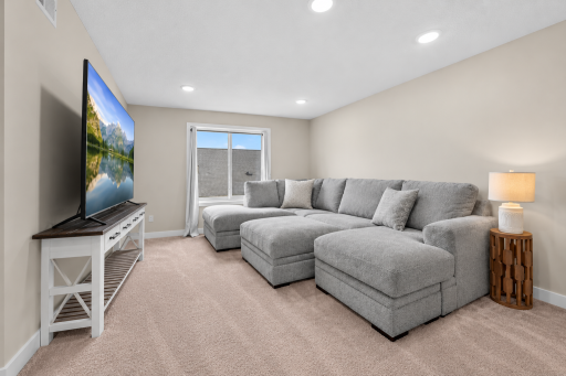 Spacious additional living area with recessed lighting and large window