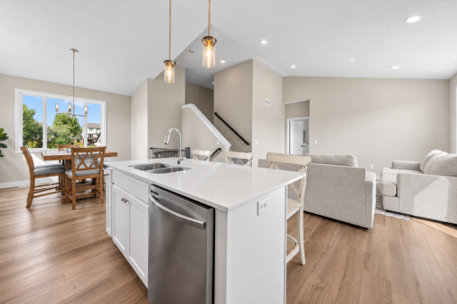 The open layout flows seamlessly into the dining and living areas, creating a spacious, connected main level.