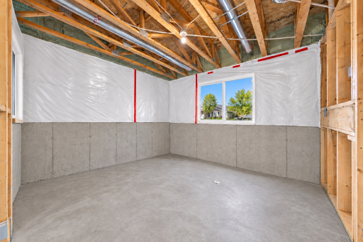 Unfinished lower-level room with window and excellent potential for future additional bedroom or office space.