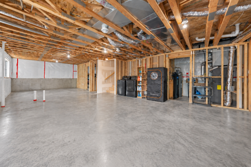 Unfinished walkout lower level offers excellent potential for future finished space, already framed for a fourth bedroom and roughed in for an additional bathroom, ready for your finishing touches.
