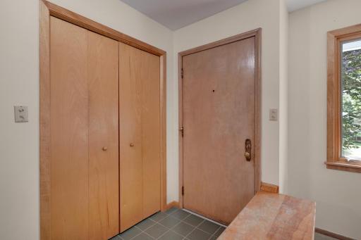 Tiled front foyer with closet.