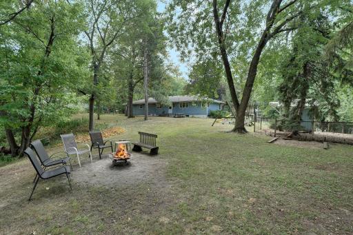 Looking from the northwest area of the lot. Chicken coop and kids play set on right of picture.