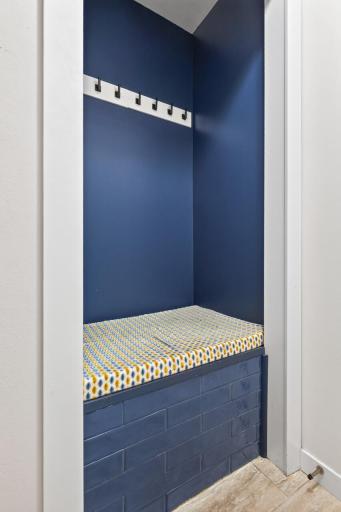This cute nook greets you as you walk in the front door, convenient bench and hooks for coats.