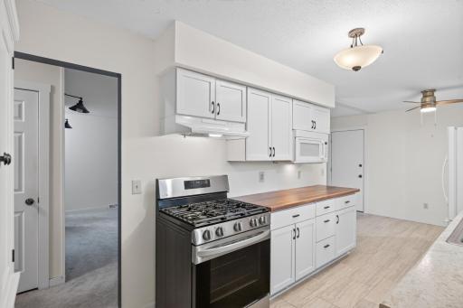 5 burner gas stove, bright white cabinets, plenty of countertop space for the chef!