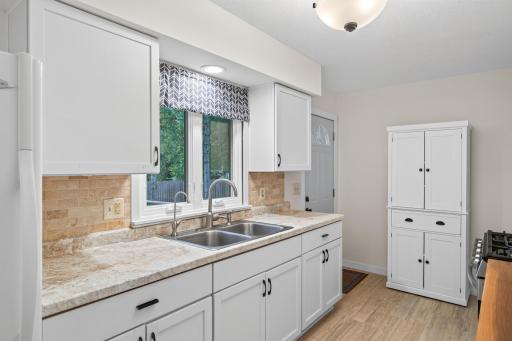 Another view of the kitchen from the dining area. Additional free standing cabinet for even more storage.