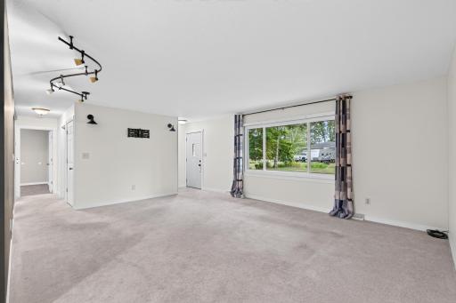 The room is quite large with newer carpeting.