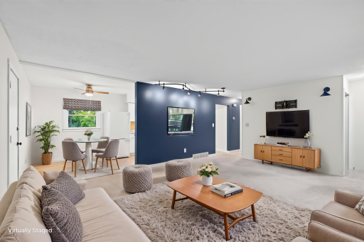 This accent wall adds to the charm. Living room is open to the dining area. This room is large enough to add a table by the accent wall for those larger gatherings.
