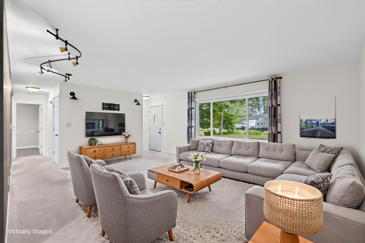 The living room is bright and sunny with the oversized picture window. Plenty of options on furniture arrangement.