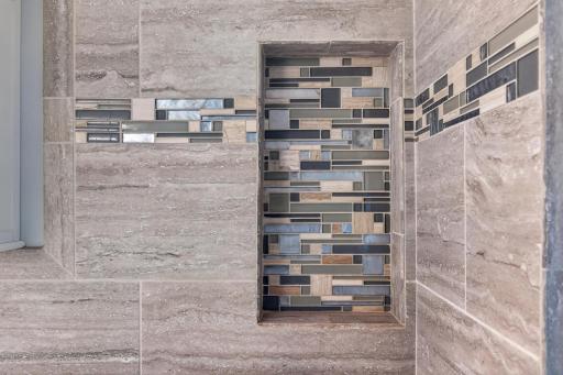 Custom tile with a recessed tile box for your shower accessories.