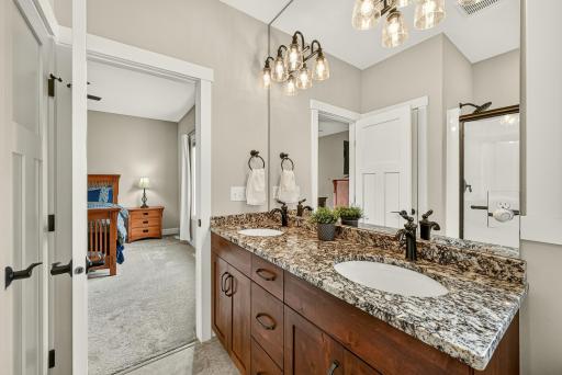 Primary bathroom with dual sinks and shower.