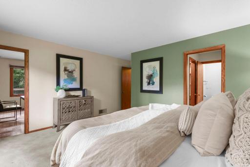 Another view of the primary bedroom with access to the primary walk-through bathroom and bedroom two.